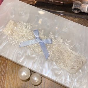 Elegant Cream Lace Garter with Blue Bow